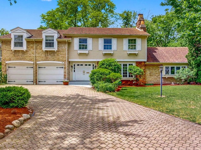 140 N Quincy St, Hinsdale, IL 60521 - view of front of house featuring an attached garage, a chimney, decorative driveway, brick siding, and a front lawn