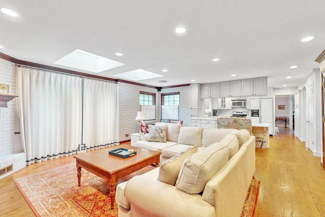 140 N Quincy St, Hinsdale, IL 60521 - living area with a skylight, light wood-style floors, recessed lighting, and crown molding