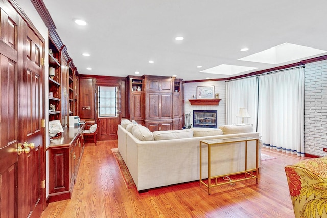 140 N Quincy St, Hinsdale, IL 60521 - living room featuring light wood-style floors, a brick fireplace, a skylight, recessed lighting, and crown molding