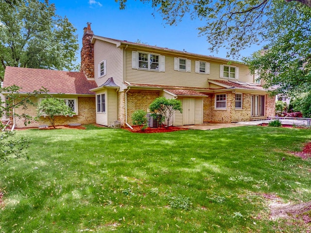 140 N Quincy St, Hinsdale, IL 60521 - view of front of home with a chimney, a patio area, a front lawn, and brick siding
