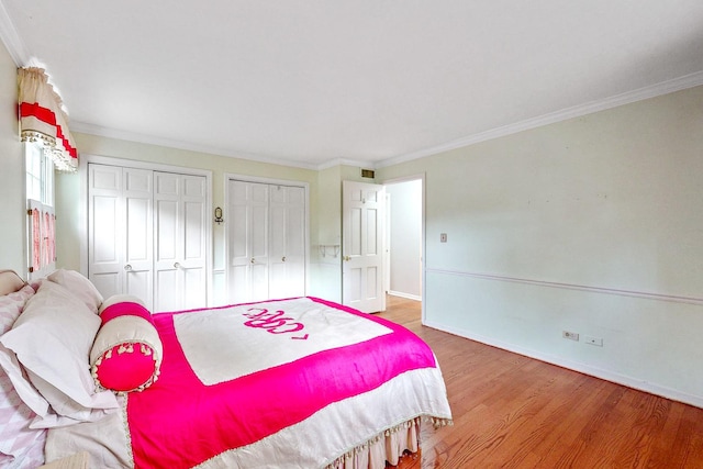 140 N Quincy St, Hinsdale, IL 60521 - bedroom with multiple closets, wood finished floors, ornamental molding, and baseboards
