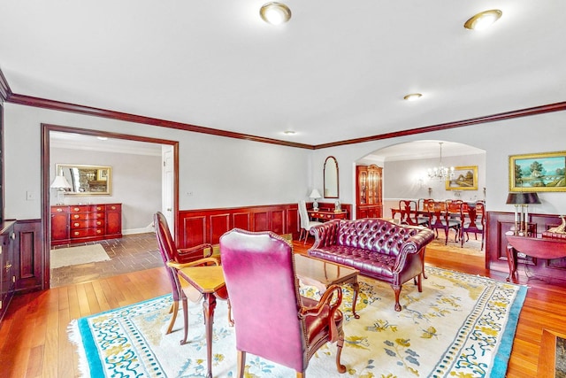 140 N Quincy St, Hinsdale, IL 60521 - living area with a wainscoted wall, arched walkways, crown molding, a chandelier, and hardwood / wood-style flooring