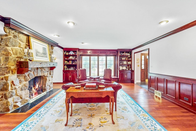 140 N Quincy St, Hinsdale, IL 60521 - living area with ornamental molding, wood finished floors, built in shelves, wainscoting, and a fireplace