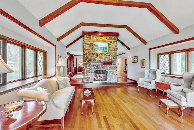 140 N Quincy St, Hinsdale, IL 60521 - living area featuring arched walkways, a fireplace, beamed ceiling, wood finished floors, and high vaulted ceiling