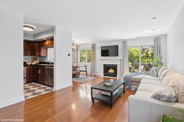 23 Foxcroft Rd Unit 235, Naperville, IL 60565 - living room featuring light wood-type flooring and a lit fireplace