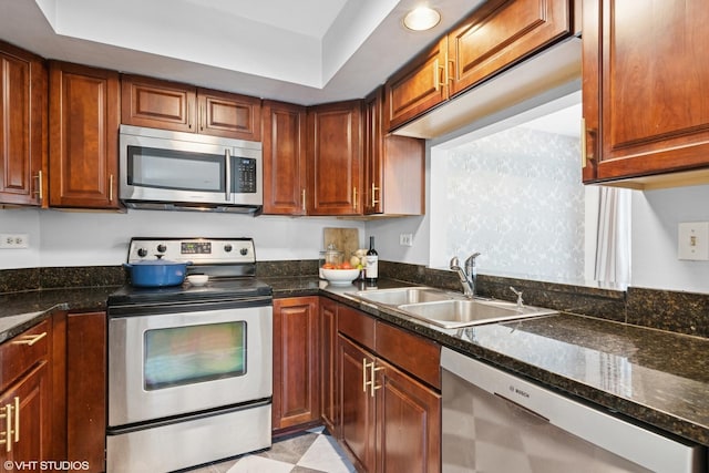 23 Foxcroft Rd Unit 235, Naperville, IL 60565 - kitchen with appliances with stainless steel finishes, dark stone countertops, and brown cabinetry