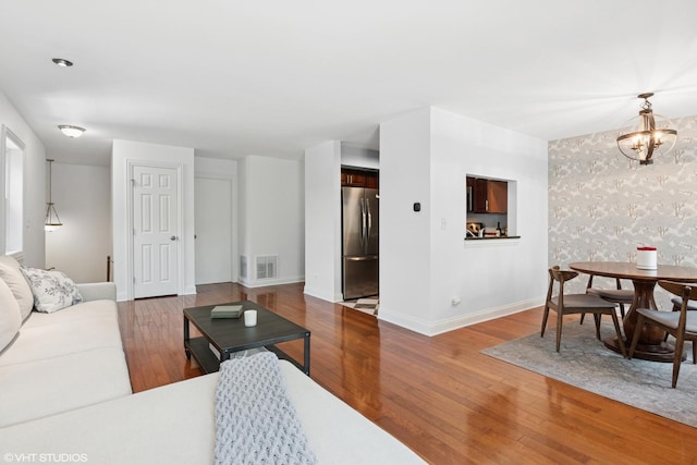23 Foxcroft Rd Unit 235, Naperville, IL 60565 - living room with wood finished floors, wallpapered walls, and a chandelier