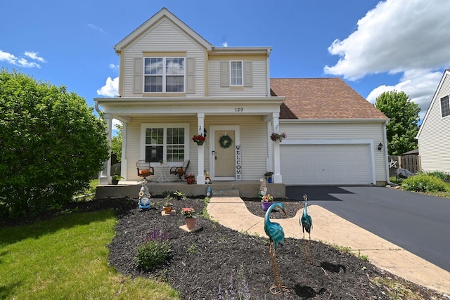 129 W Hampton Ct, Round Lake, IL 60073 - traditional home featuring covered porch, driveway, and an attached garage