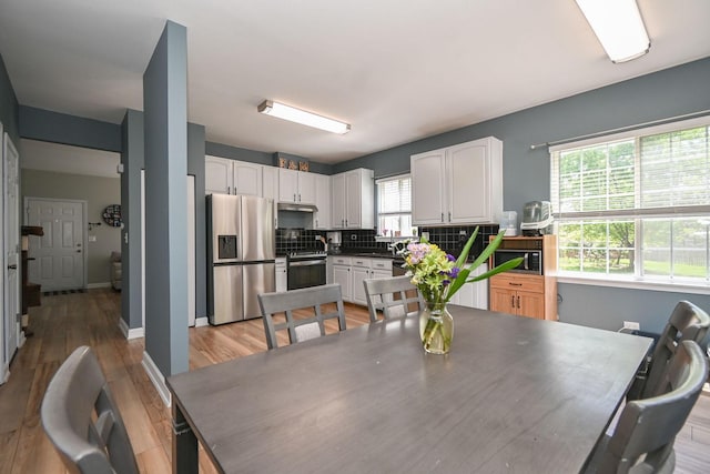 129 W Hampton Ct, Round Lake, IL 60073 - dining area with light wood-style floors and baseboards