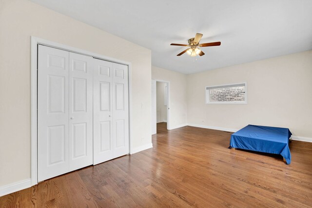 447 W 27th St, Chicago, IL 60616 - unfurnished bedroom with wood finished floors, baseboards, a closet, and ceiling fan