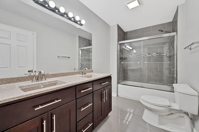 447 W 27th St, Chicago, IL 60616 - bathroom featuring toilet, double vanity, bath / shower combo with glass door, and tile patterned flooring