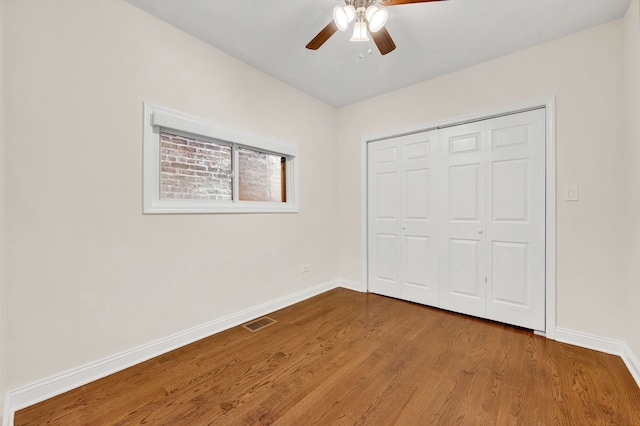 447 W 27th St, Chicago, IL 60616 - unfurnished bedroom featuring wood finished floors, baseboards, a closet, and ceiling fan