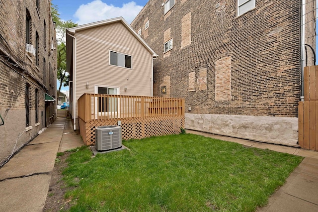 447 W 27th St, Chicago, IL 60616 - rear view of house featuring central AC, a wooden deck, a yard, and brick siding