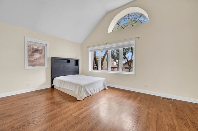 447 W 27th St, Chicago, IL 60616 - bedroom featuring wood finished floors, high vaulted ceiling, and baseboards