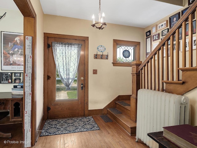 217 S Craig Pl, Lombard, IL 60148 - entryway with radiator heating unit, stairway, wood finished floors, a chandelier, and baseboards