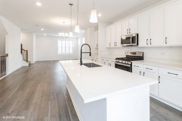 1533 Executive Way, Des Plaines, IL 60018 - kitchen with stainless steel appliances, an island with sink, white cabinetry, and recessed lighting