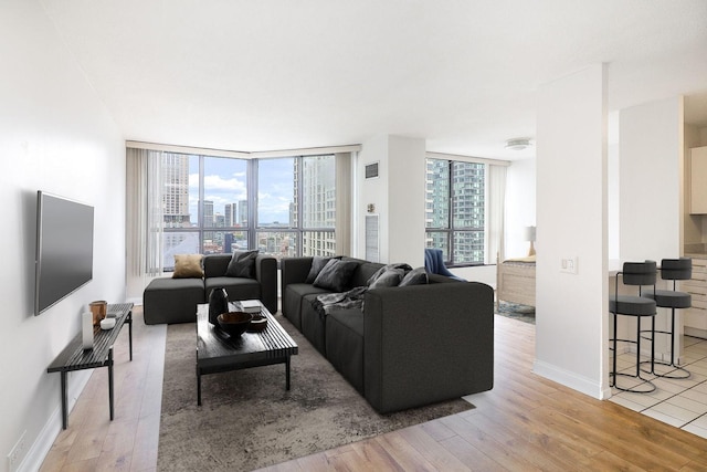405 N Wabash Ave Unit 2204, Chicago, IL 60611 - living area featuring light wood finished floors, a wall of windows, and baseboards