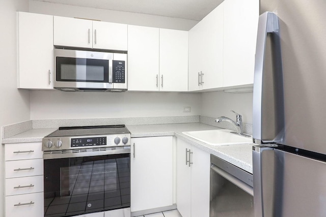 405 N Wabash Ave Unit 2204, Chicago, IL 60611 - kitchen featuring appliances with stainless steel finishes, a sink, light countertops, and white cabinetry