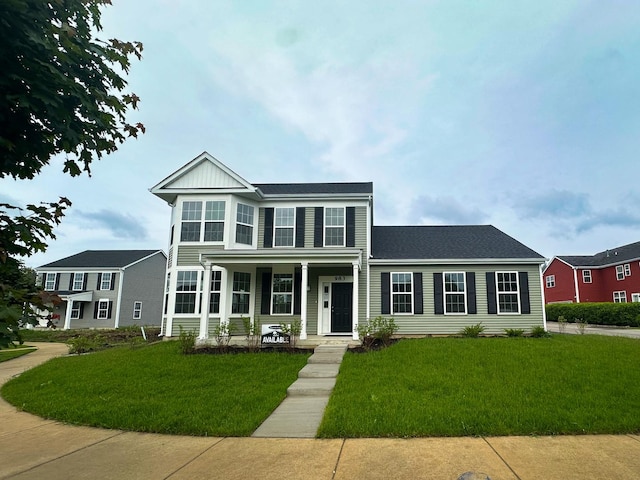 983 Celebration Dr, Aurora, IL 60504 - view of front facade with covered porch, a front yard, and roof with shingles