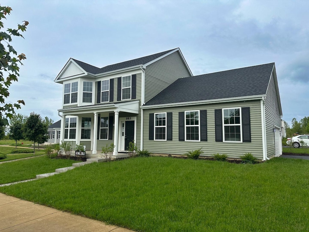 983 Celebration Dr, Aurora, IL 60504 - view of front of house featuring a porch, a front lawn, and a shingled roof