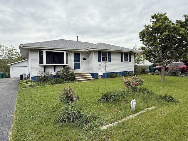 3357 D Hutchison Ave, Joliet, IL 60431 - view of front facade featuring a front lawn, a garage, central AC unit, and roof with shingles