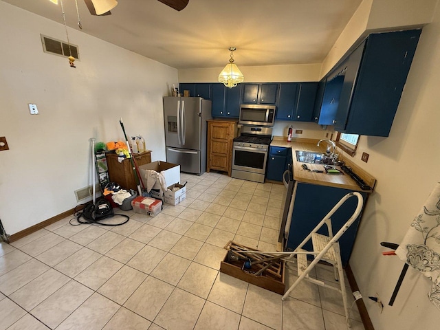 3357 D Hutchison Ave, Joliet, IL 60431 - kitchen featuring appliances with stainless steel finishes, blue cabinetry, a sink, light tile patterned floors, and a ceiling fan