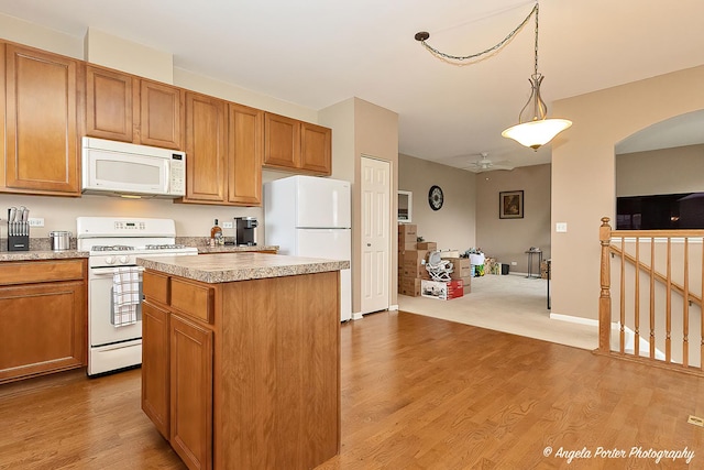 4219 Savoy Ln Unit 4219, Mchenry, IL 60050 - kitchen with white appliances, a kitchen island, light wood-type flooring, light countertops, and open floor plan