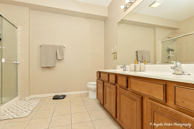 4219 Savoy Ln Unit 4219, Mchenry, IL 60050 - bathroom with a tile shower, tile patterned floors, toilet, double vanity, and baseboards