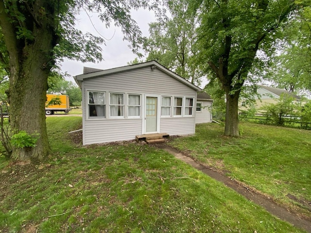 18020 Ridgeland Ave, Lansing, IL 60438 - bungalow-style home with entry steps and a front lawn