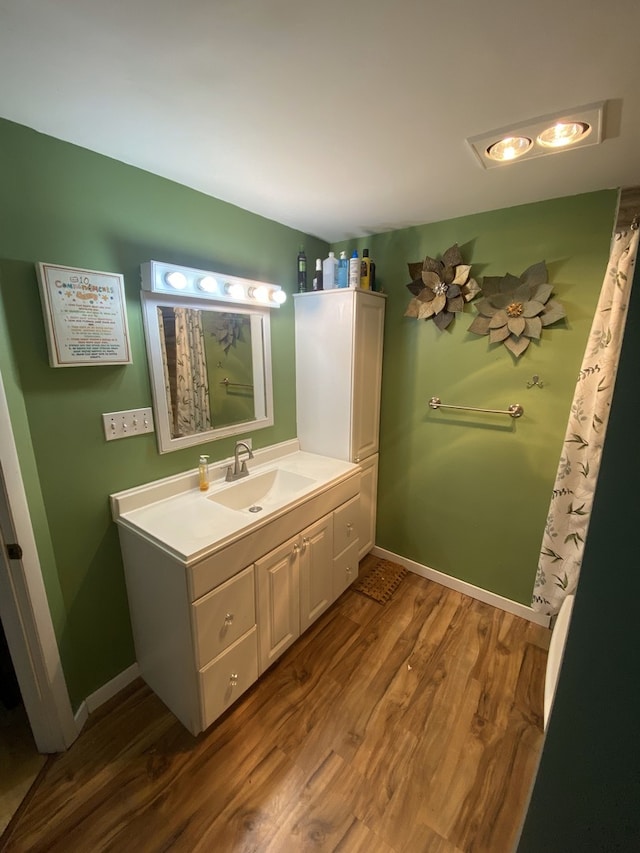 18020 Ridgeland Ave, Lansing, IL 60438 - full bath featuring vanity, wood finished floors, and baseboards