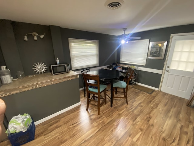 18020 Ridgeland Ave, Lansing, IL 60438 - dining space featuring wood finished floors, ceiling fan, and baseboards
