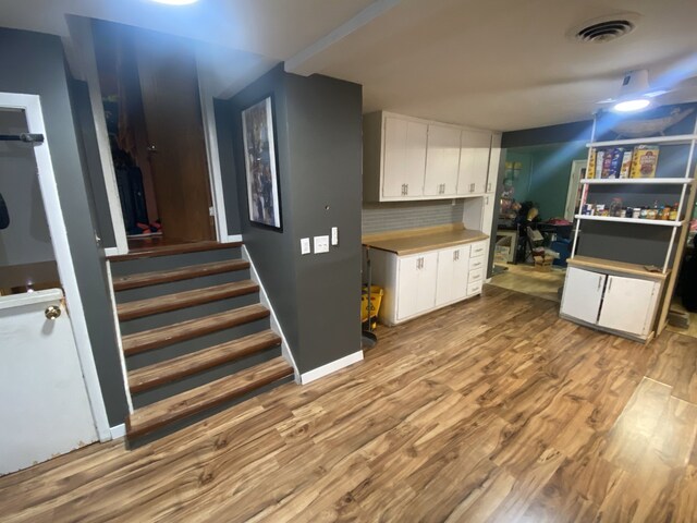 18020 Ridgeland Ave, Lansing, IL 60438 - kitchen featuring white cabinets and wood finished floors