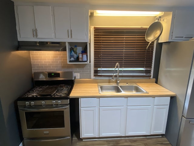 18020 Ridgeland Ave, Lansing, IL 60438 - kitchen featuring stainless steel appliances, a sink, under cabinet range hood, and light countertops