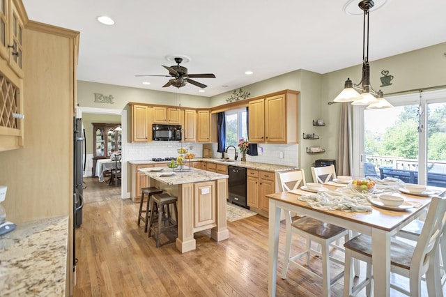 7N310 Ridge Line Rd, Saint Charles, IL 60175 - kitchen featuring black appliances, a sink, ceiling fan, a center island, and decorative backsplash