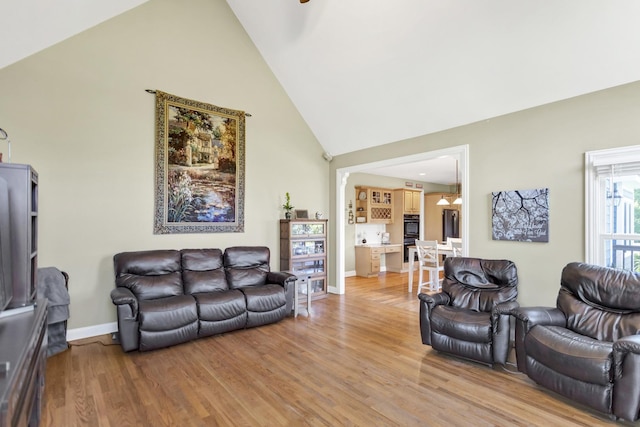 7N310 Ridge Line Rd, Saint Charles, IL 60175 - living room featuring high vaulted ceiling, baseboards, and light wood-style flooring