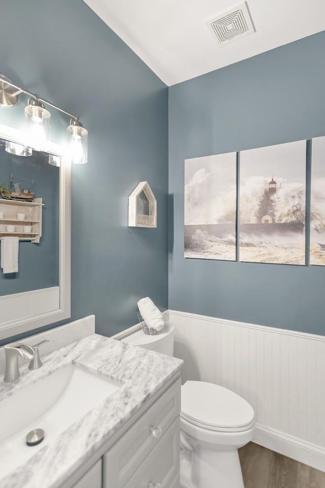 7N310 Ridge Line Rd, Saint Charles, IL 60175 - half bath with a wainscoted wall, toilet, vanity, and wood finished floors