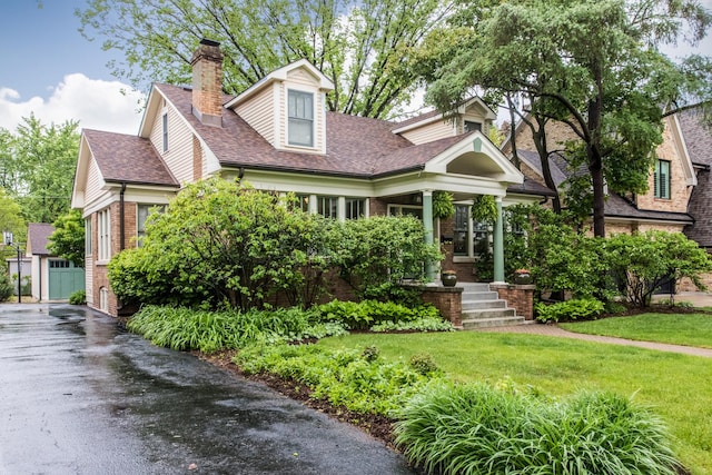 740 Wisner St, Park Ridge, IL 60068 - view of front of home with a chimney, brick siding, a front lawn, a shingled roof, and a porch