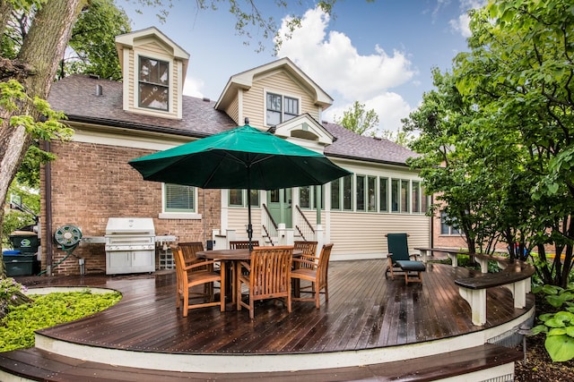 740 Wisner St, Park Ridge, IL 60068 - rear view of property featuring a deck, brick siding, outdoor dining area, a sunroom, and roof with shingles