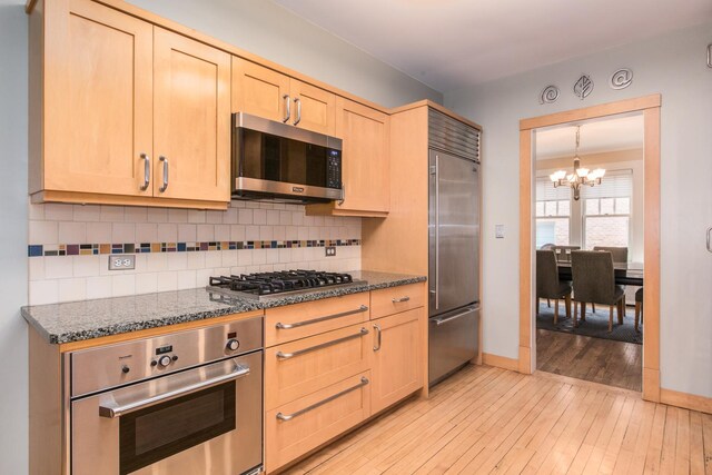 740 Wisner St, Park Ridge, IL 60068 - kitchen featuring stainless steel appliances, light brown cabinets, a chandelier, light wood-style flooring, and backsplash