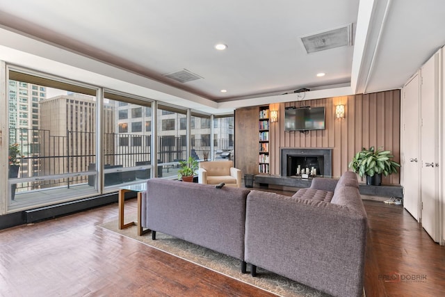 201 E Chestnut St Unit 3C, Chicago, IL 60611 - living room with a fireplace with raised hearth, wood finished floors, and recessed lighting