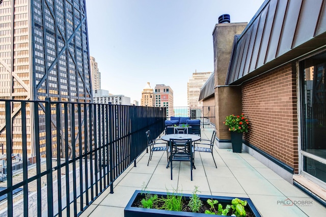 201 E Chestnut St Unit 3C, Chicago, IL 60611 - view of patio / terrace with a city view, a balcony, and outdoor dining space