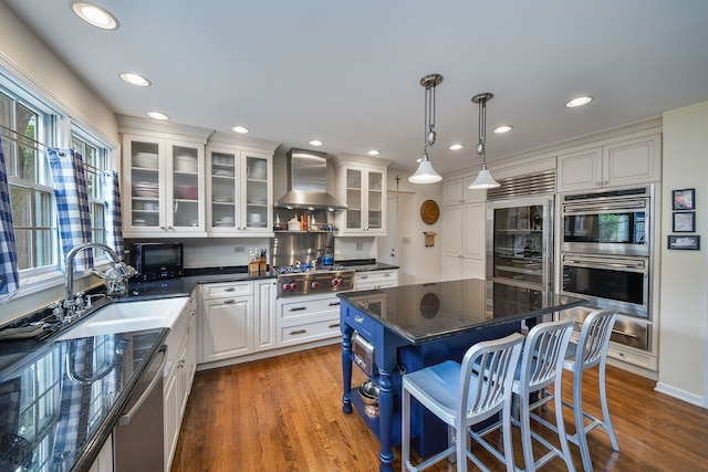 5234 Cedar Ct, Lisle, IL 60532 - kitchen featuring wall chimney range hood, stainless steel appliances, white cabinetry, a kitchen breakfast bar, and dark wood-type flooring