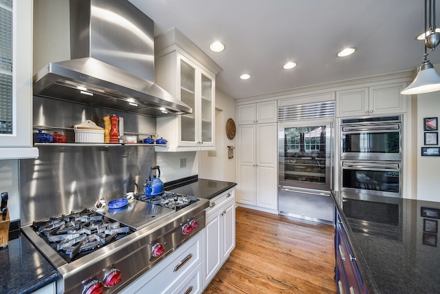 5234 Cedar Ct, Lisle, IL 60532 - kitchen featuring wall chimney range hood, stainless steel appliances, white cabinets, glass insert cabinets, and light wood-style flooring