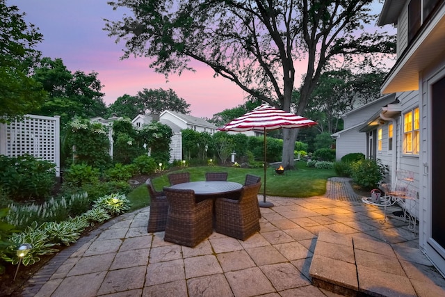 5234 Cedar Ct, Lisle, IL 60532 - patio terrace at dusk with a patio, a lawn, and outdoor dining area
