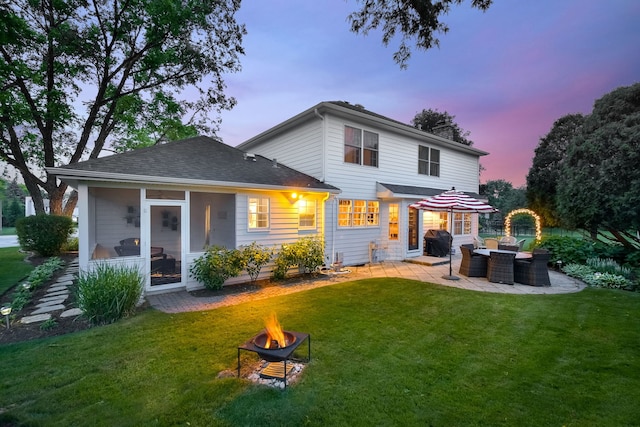5234 Cedar Ct, Lisle, IL 60532 - back of property at dusk featuring an outdoor fire pit, a patio, a lawn, and a chimney
