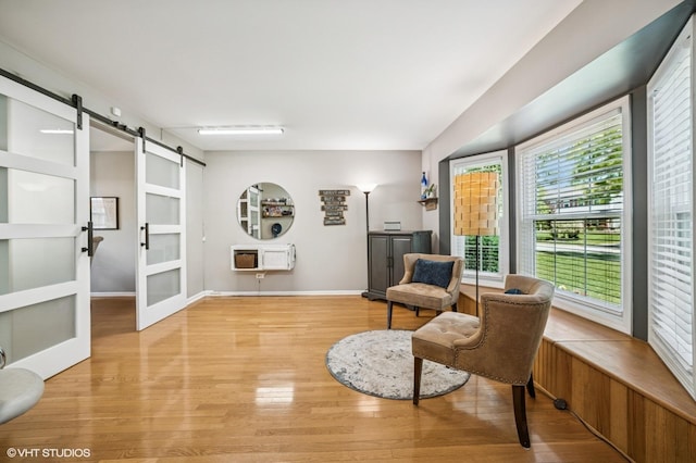 1250 Fernleaf Dr, Crystal Lake, IL 60014 - living area featuring a barn door, light wood-type flooring, heating unit, and baseboards