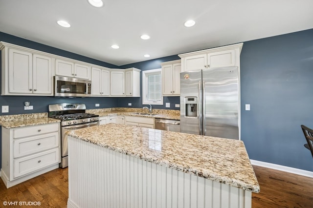 1250 Fernleaf Dr, Crystal Lake, IL 60014 - kitchen featuring appliances with stainless steel finishes, dark wood-type flooring, light stone countertops, a sink, and recessed lighting