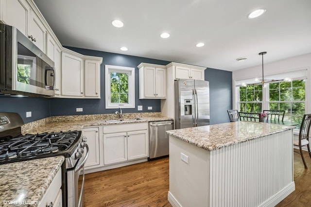 1250 Fernleaf Dr, Crystal Lake, IL 60014 - kitchen featuring appliances with stainless steel finishes, a sink, wood finished floors, white cabinets, and recessed lighting