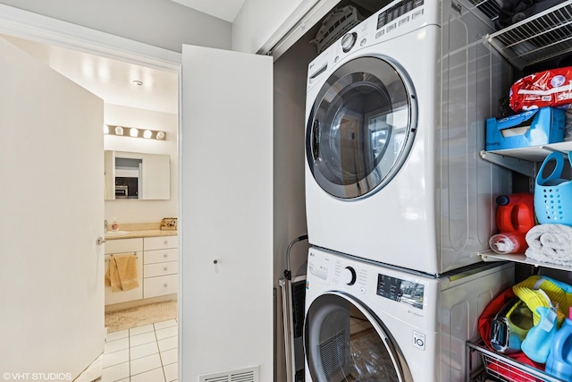 8 E Randolph St Unit 2407, Chicago, IL 60601 - laundry room with stacked washing machine and dryer and tile patterned floors