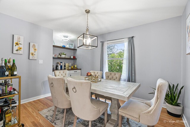 384 Glen Farm Ln, Lake Zurich, IL 60047 - dining space with light wood-style flooring, baseboards, and a chandelier